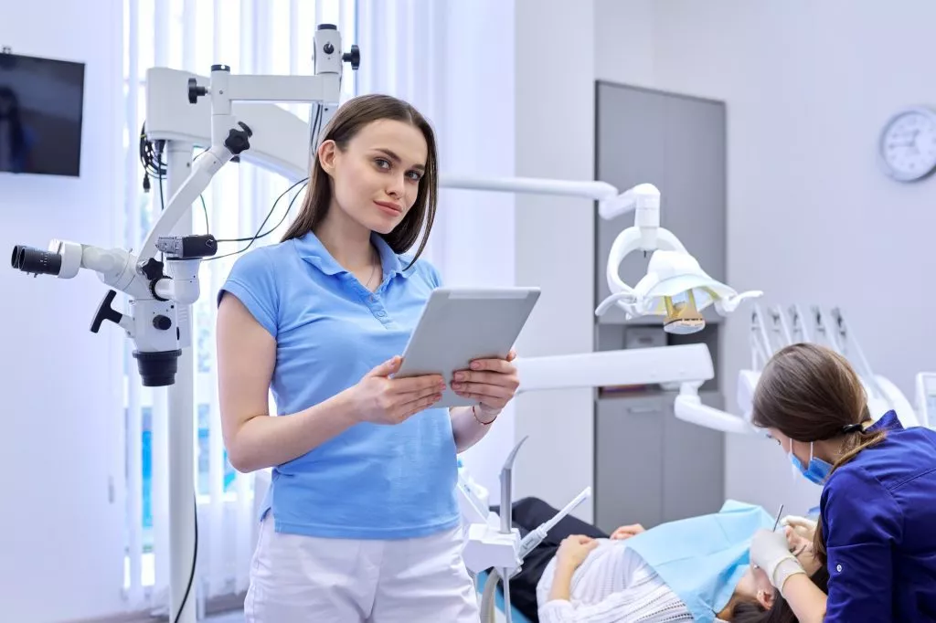 Portrait of dentist doctor with digital tablet