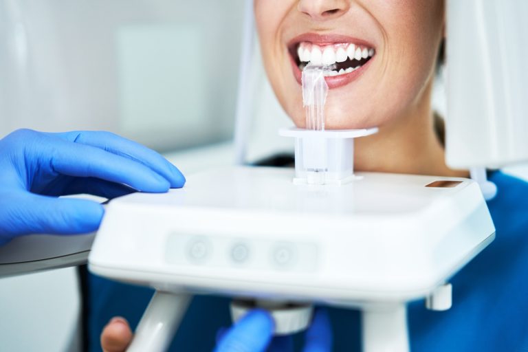 Dental X-rays 6 Dentist taking a panoramic digital xray of a patients teeth