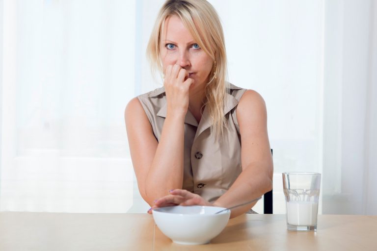 Young beautiful woman pushes away bowl of food. healthy lifestyle diet, treatment fasting concept.