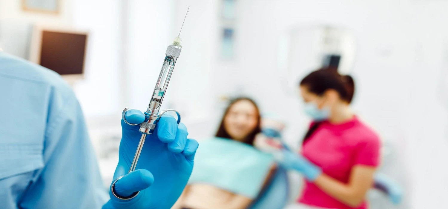 dentist holding injection
