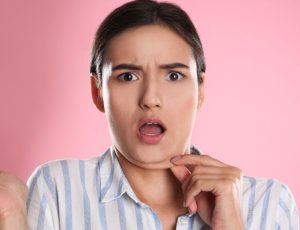 a girl touching her chin