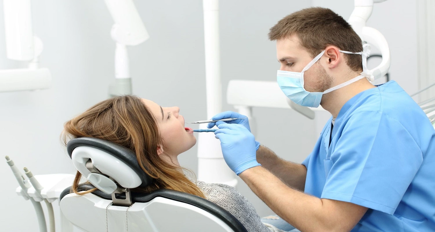 dentist performs cleaning and a check-up
