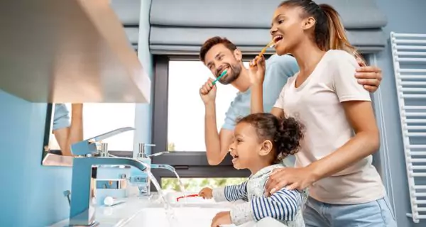 What daily habits reinforce family dental care?