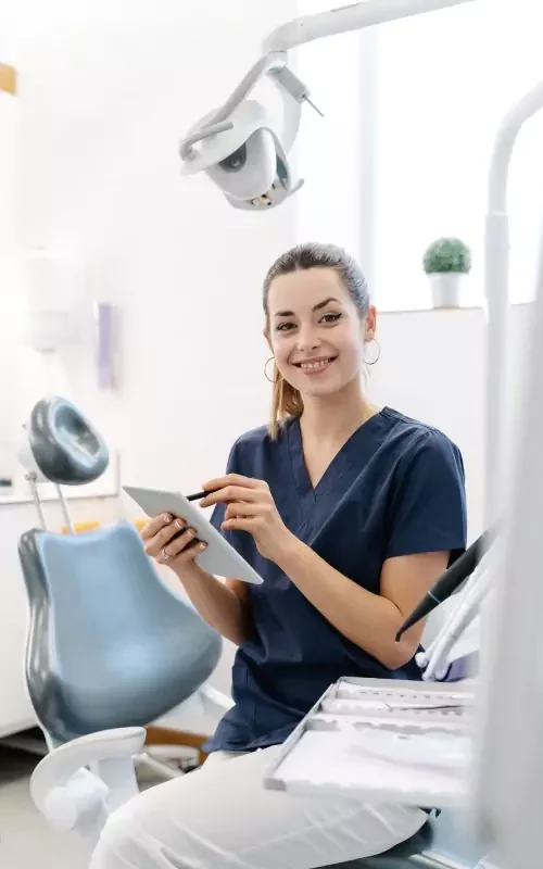 young-nurse-smiles-in-the-dental-office-before-receiving-the-patient-and-handles-a-tablet-q1hgswl3j2h7bcre4ry89dd337xp6usz2blzu0nolc-64dce86f74efa